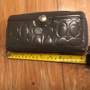 Patent leather grey Coach wallet.